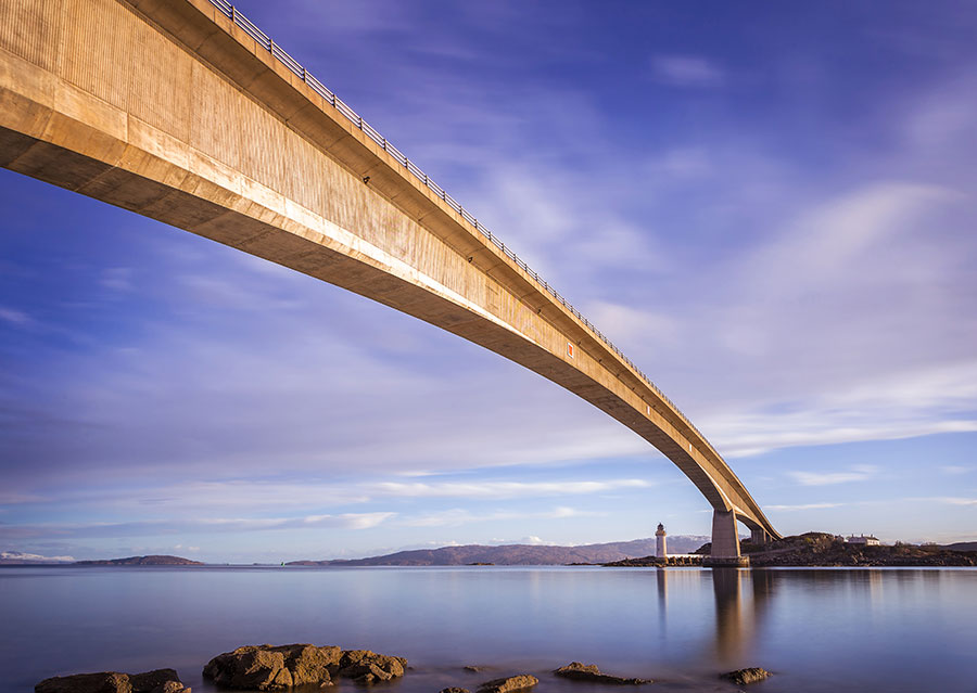 picture of a bridge reaching over a large area of water