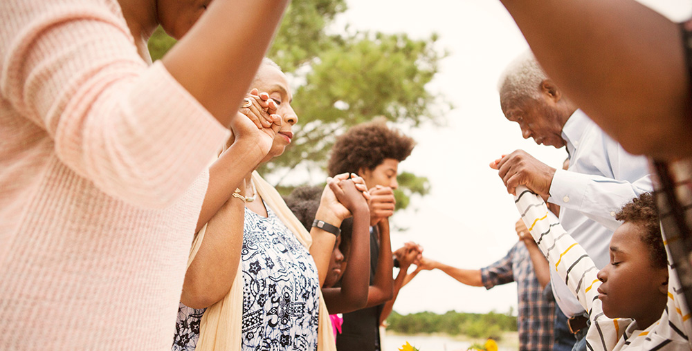 Group of multigenerational people praying