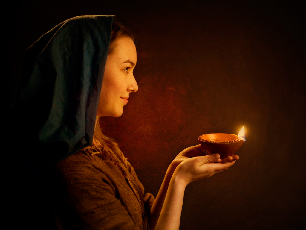 One of the 10 virgins with a lit lamp